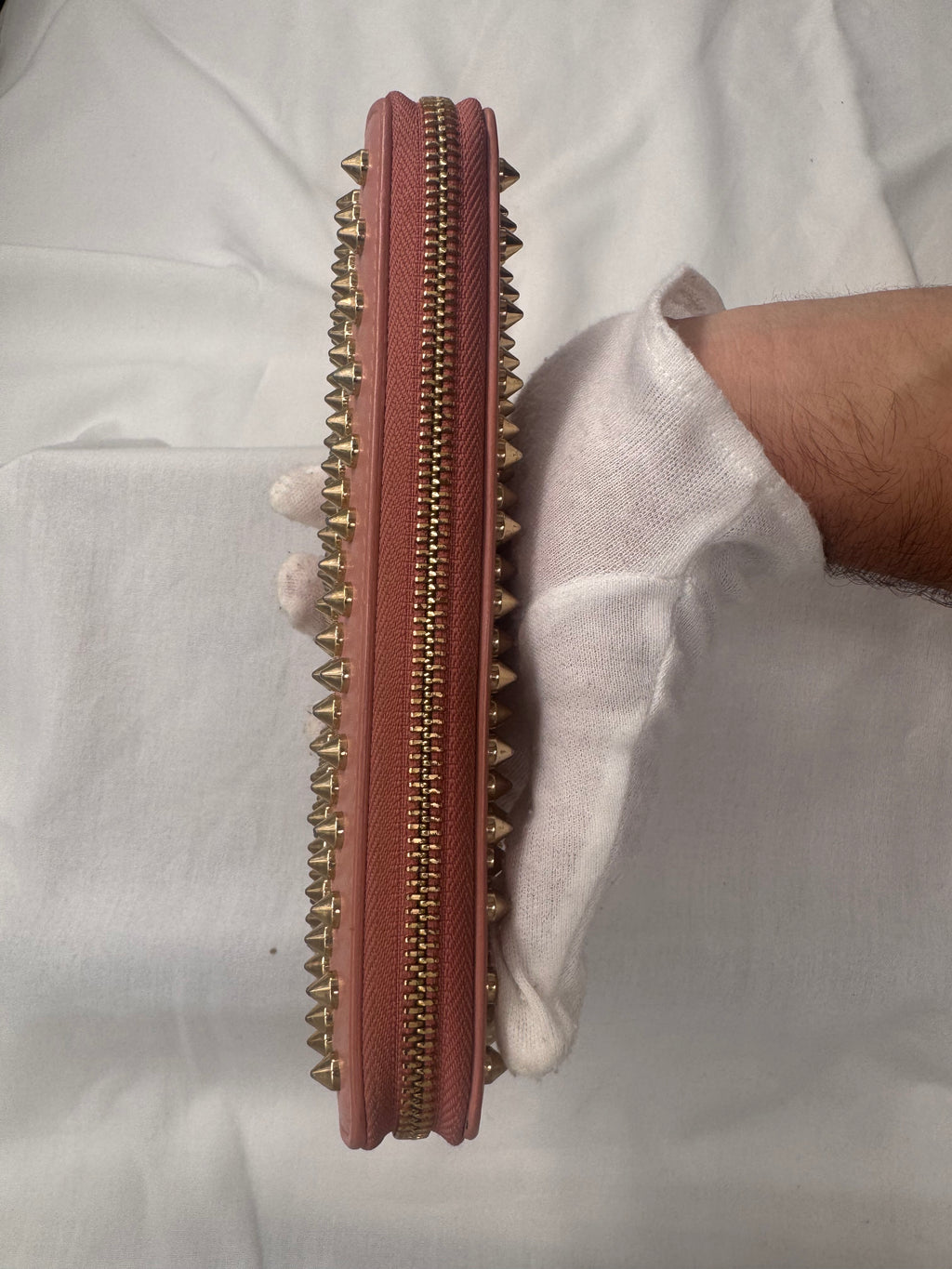 ארנק כריסטיאן לובוטן מעור ורוד בעיטור ניטים מוזהבים